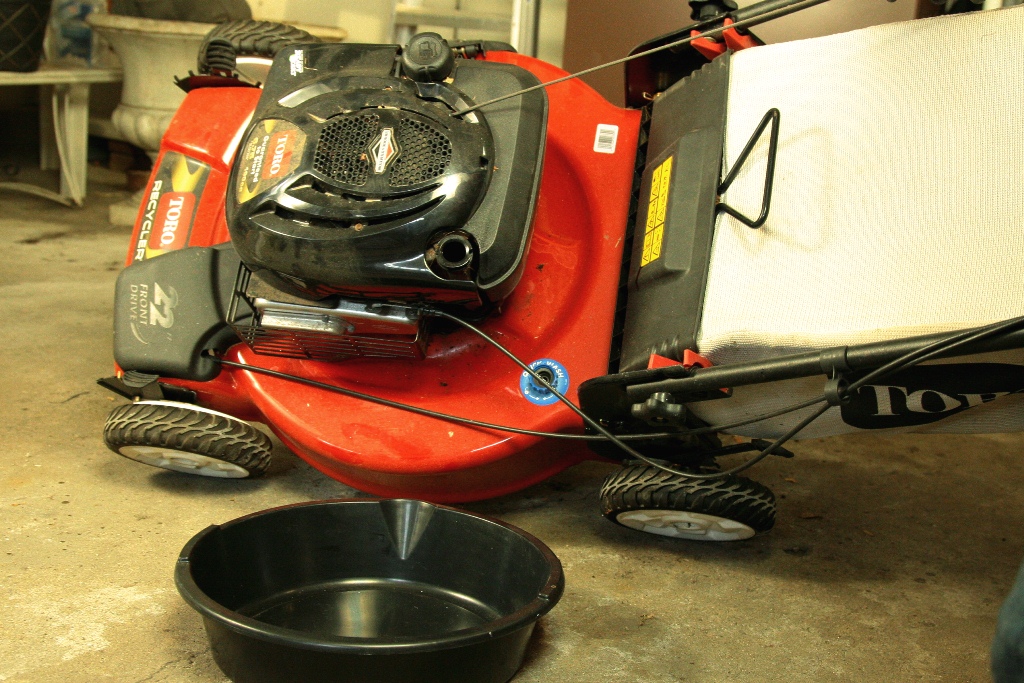 Pouring oil out of push lawn mower
